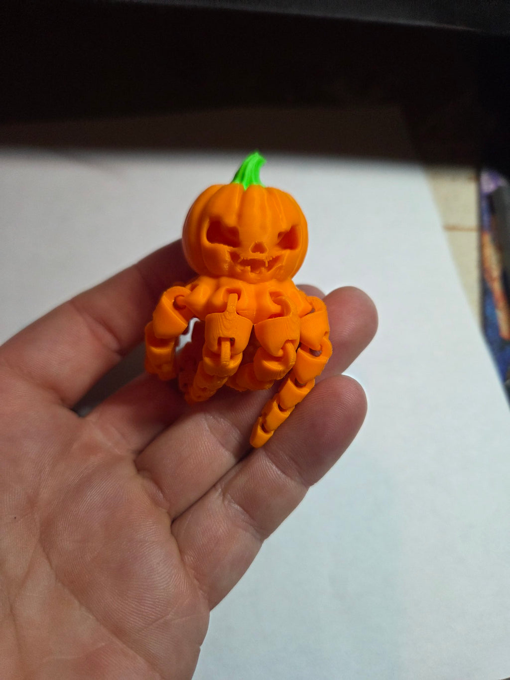 Articulated pumpkin octopus held in hand